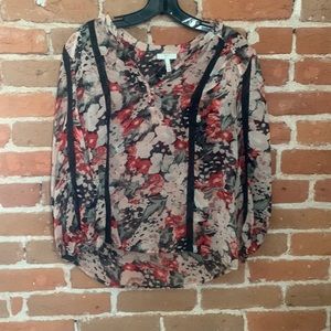 Semi-sheer Joie silk top with floral pattern and lace detail. Dress up or down
